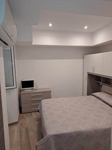 a bedroom with a bed and a dresser in it at Le quattro esse in Ventimiglia