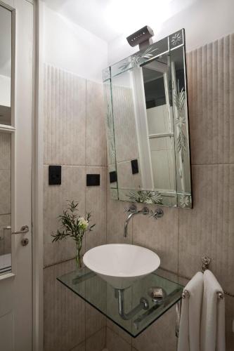 a bathroom with a sink and a mirror at San Telmo Suites in Buenos Aires