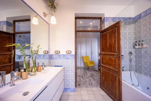a bathroom with two sinks and a shower at Portrait Boutique Villa in Valencia