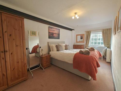a bedroom with a large bed and a window at 2 Hope Cottage in Spilsby