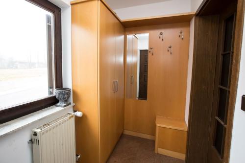 a hallway with a door and a window at Holiday House Klemenčič in Bohinj
