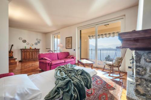 a bedroom with a bed and a living room at Luxury Apartment with lake view near Varenna in Fiumelatte
