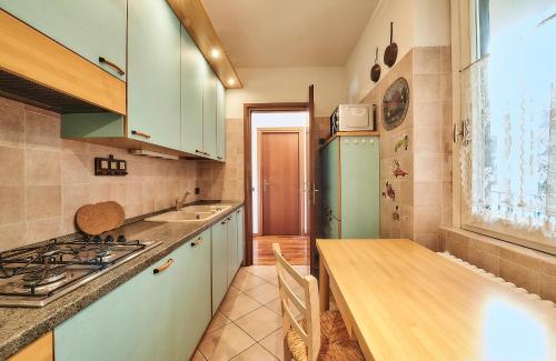 a kitchen with a counter and a sink and a stove at Luxury Apartment with lake view near Varenna in Fiumelatte