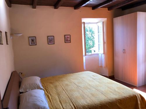 a bedroom with a large bed and a window at La Ca del Bicc in Luino