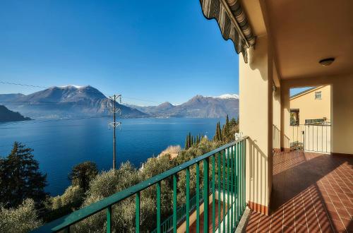 a house with a balcony with a view of a lake at Luxury Apartment with lake view near Varenna in Fiumelatte