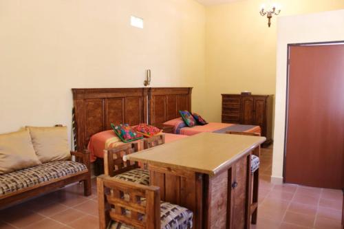 a living room with two beds and a couch at Hotel suites Guanajuato Centrico in Guanajuato