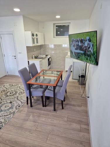 a kitchen and dining room with a table and chairs at Zoka in Surčin