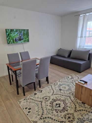 a living room with a table and chairs and a couch at Zoka in Surčin