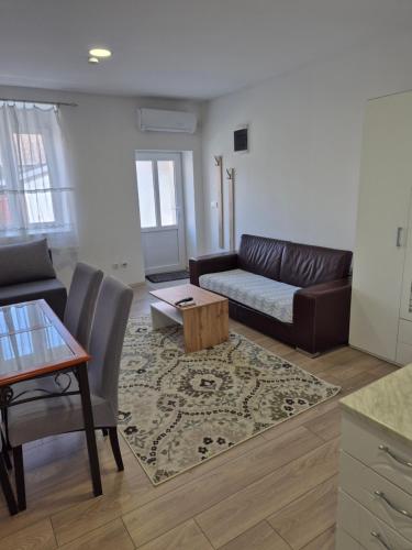 a living room with a couch and a table at Zoka in Surčin