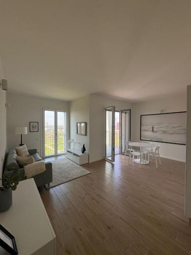 a living room with a couch and a table at Milano Panorama Home - Luminous with private Garage in Milan