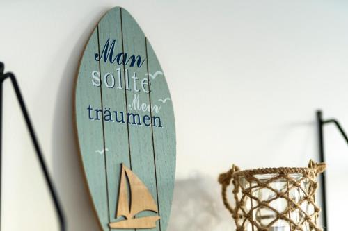 a surfboard is hanging on a wall at Ferienwohnung Coasty - Timmendorfer Strand in Timmendorfer Strand