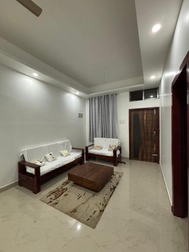 a living room with two beds and a couch at Jassy haven in Guwahati
