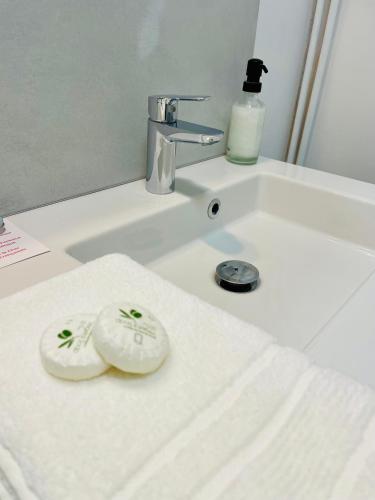 a bathroom sink with two rolls of toilet paper on it at Belle Fontaine in Bourges