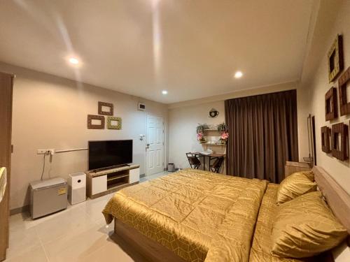 a bedroom with a bed and a flat screen tv at โรงพักบางระมาด by ModiCoff Café in Sathani Ban Chim Phali