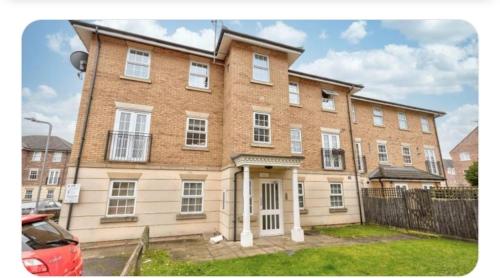 a large brick building with a gate in front of it at 1 Bedroom luxury Flat Close to town center in Northampton