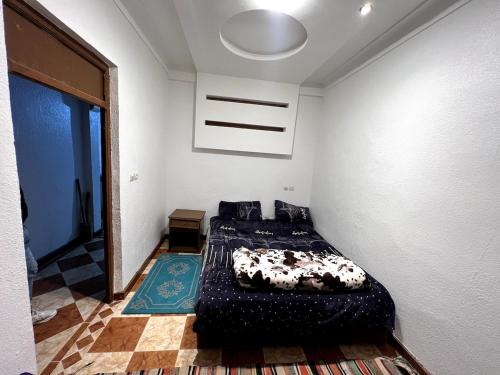 a bedroom with a bed in the corner of a room at Suite 1 in Marrakech