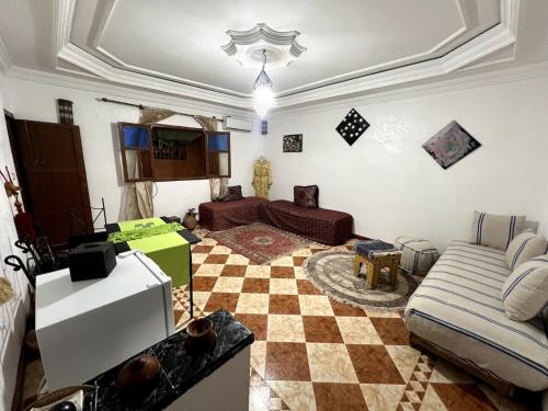 a living room with a couch and a checkered floor at Suite 1 in Marrakech