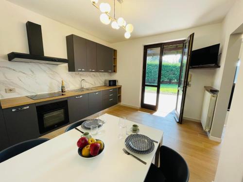a kitchen with a table with a bowl of fruit on it at Holiday Flat in Villa San Gregorio with pool in Melazzo