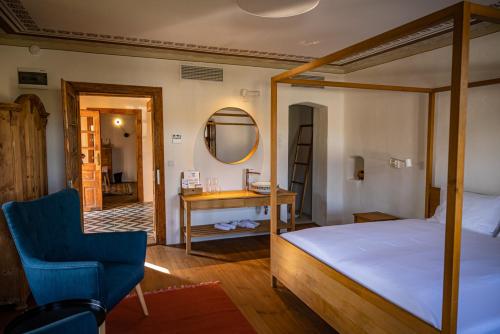 a bedroom with a bed and a desk and a chair at Almalomb Apartman in Hosszúhétény
