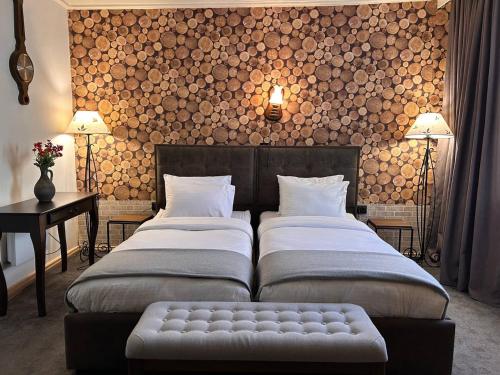 a bedroom with two beds and a bench in it at Hnameni Stepanavan Guesthouse - Hotel in Stepʼanavan