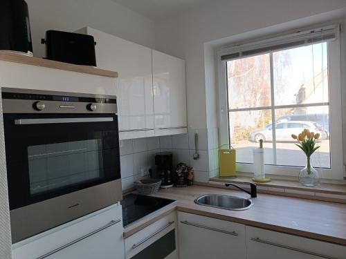 a kitchen with a sink and a window at Ostseemeerchen in Zingst