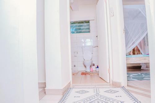 a bathroom with a toilet in a room at Stella Residence in Malindi