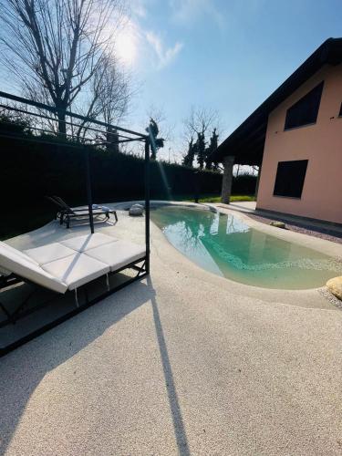 a bed sitting next to a swimming pool at Holiday Flat in Villa San Gregorio with pool in Melazzo