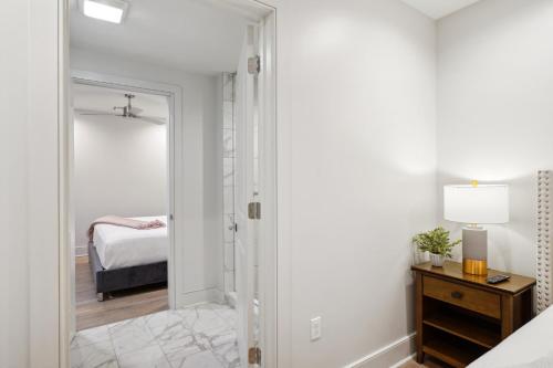 a bedroom with a door leading into a bedroom with a bed at The Eleanor New Orleans in New Orleans