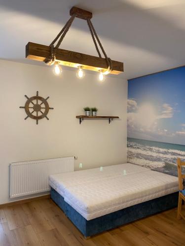 a bed in a room with the ocean at Bulwar17 in Krynica Morska