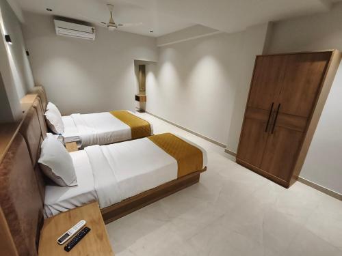 Hotel Beverly Plaza Kozhikodeにあるベッド