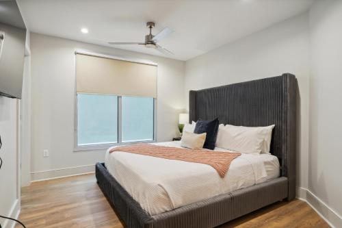 a bedroom with a large bed and a window at The Eleanor New Orleans in New Orleans