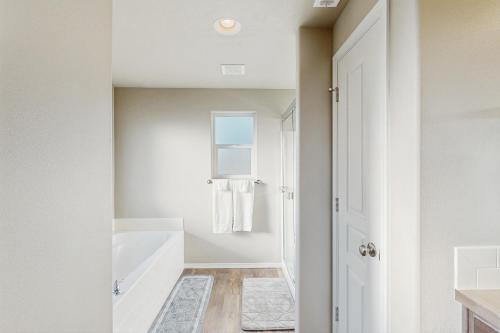 a white bathroom with a tub and a sink at The Cozy Corner in Walla Walla