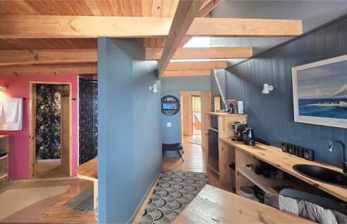 a bathroom with blue walls and wooden ceilings at Lagoon Studio - Maison Mahogany - design meets breathtaking views of lagoon in Knysna