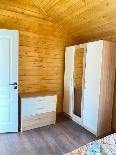 a bedroom with wooden walls and a bed and a closet at Green World in Byurakan