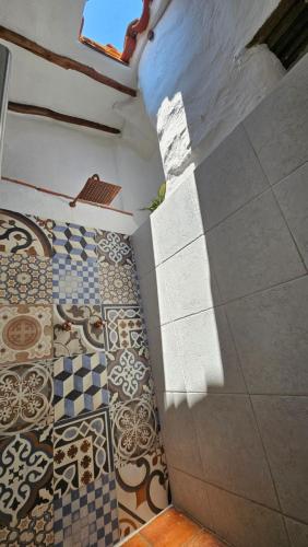 a room with tile floors and a wall with a window at Casa Raisol Barichara in Barichara