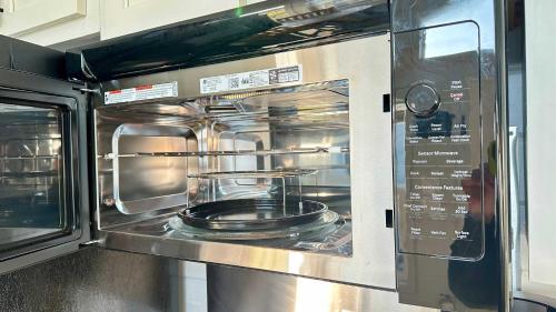 a microwave oven with a pot on top of it at Waterfront on the Bay & Close to Beach -Brand New! in Bolivar Peninsula
