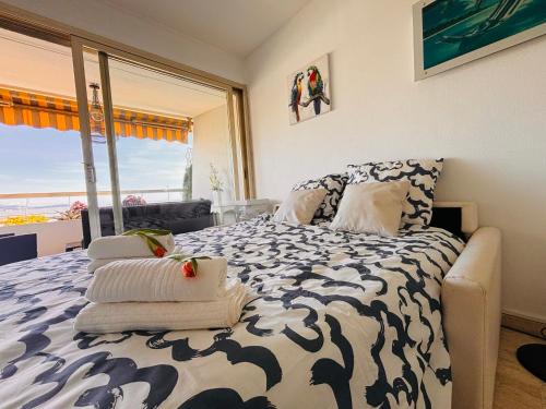 a bedroom with a bed with a view of the ocean at Marina Baie des Anges - Studio - Villeneuve-Loubet in Villeneuve-Loubet