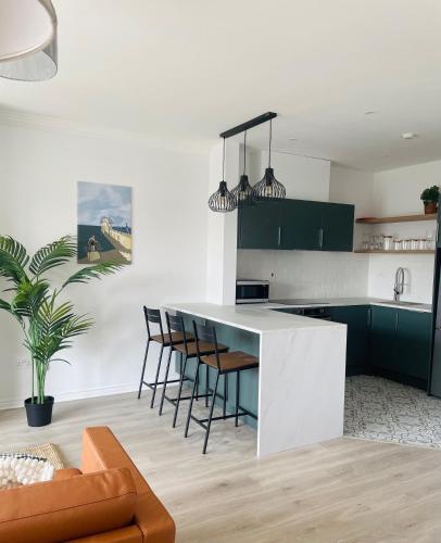 a kitchen with green cabinets and a white counter at Modern and Spacious Apt5 Sleeps 6 Free Parking in Galway