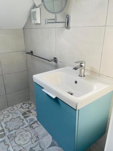a bathroom with a white sink and a mirror at Modern and Spacious Apt5 Sleeps 6 Free Parking in Galway