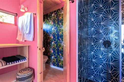 a bathroom with a shower in a pink room at Lagoon Studio - Maison Mahogany - design meets breathtaking views of lagoon in Knysna