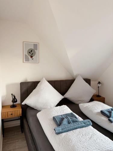 a living room with a couch with towels on it at Ferienwohnung KÖÖK Küstentraum - Modern, Balkon, Strandnah, Maisonette in Neuharlingersiel