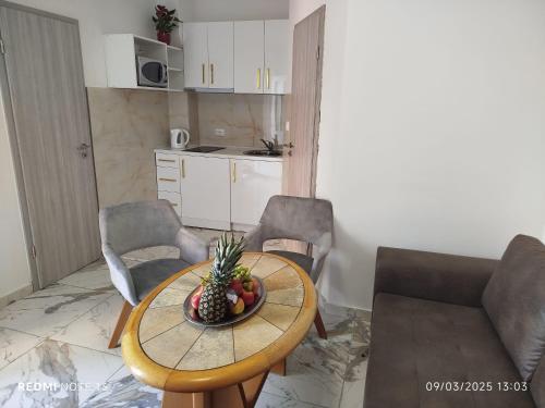a kitchen with a table with a bowl of fruit on it at Melek in Medulin