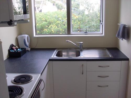 a kitchen with a sink and a window at Motel 22 in Lower Hutt