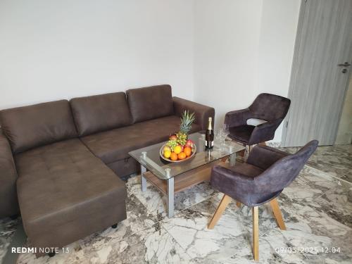 a living room with a couch and a table with fruit on it at Melek in Medulin