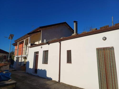 a white building with a roof at B & B Sotto al lago in Nemoli