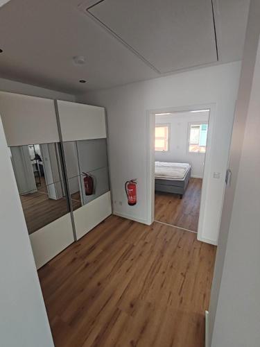 a white room with a bed and a mirror at Ferienwohnung AnKe in Bad Neuenahr-Ahrweiler