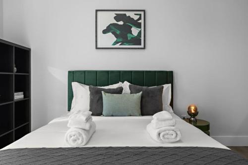a bedroom with a bed with towels on it at Chic Retreat Free Parking 30Min to NYC in Bayonne