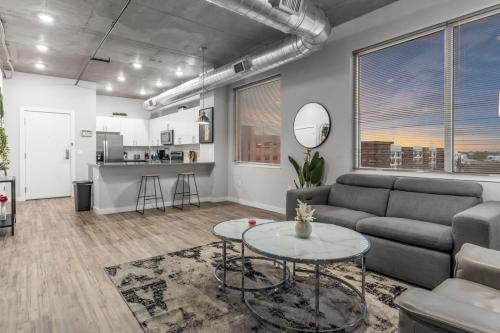 a living room with a couch and a table at Modern 2 Bed Getaway Steps from Tropicana Field in St. Petersburg