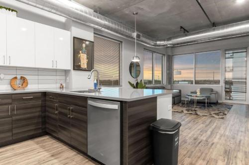 a kitchen with a sink and a counter top at Modern 2 Bed Getaway Steps from Tropicana Field in St. Petersburg