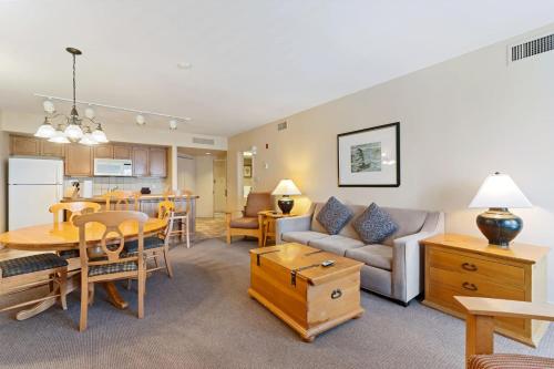 a living room with a couch and a table at Resort Style with Balcony Hot Tub and Full Kitchen in Edgar